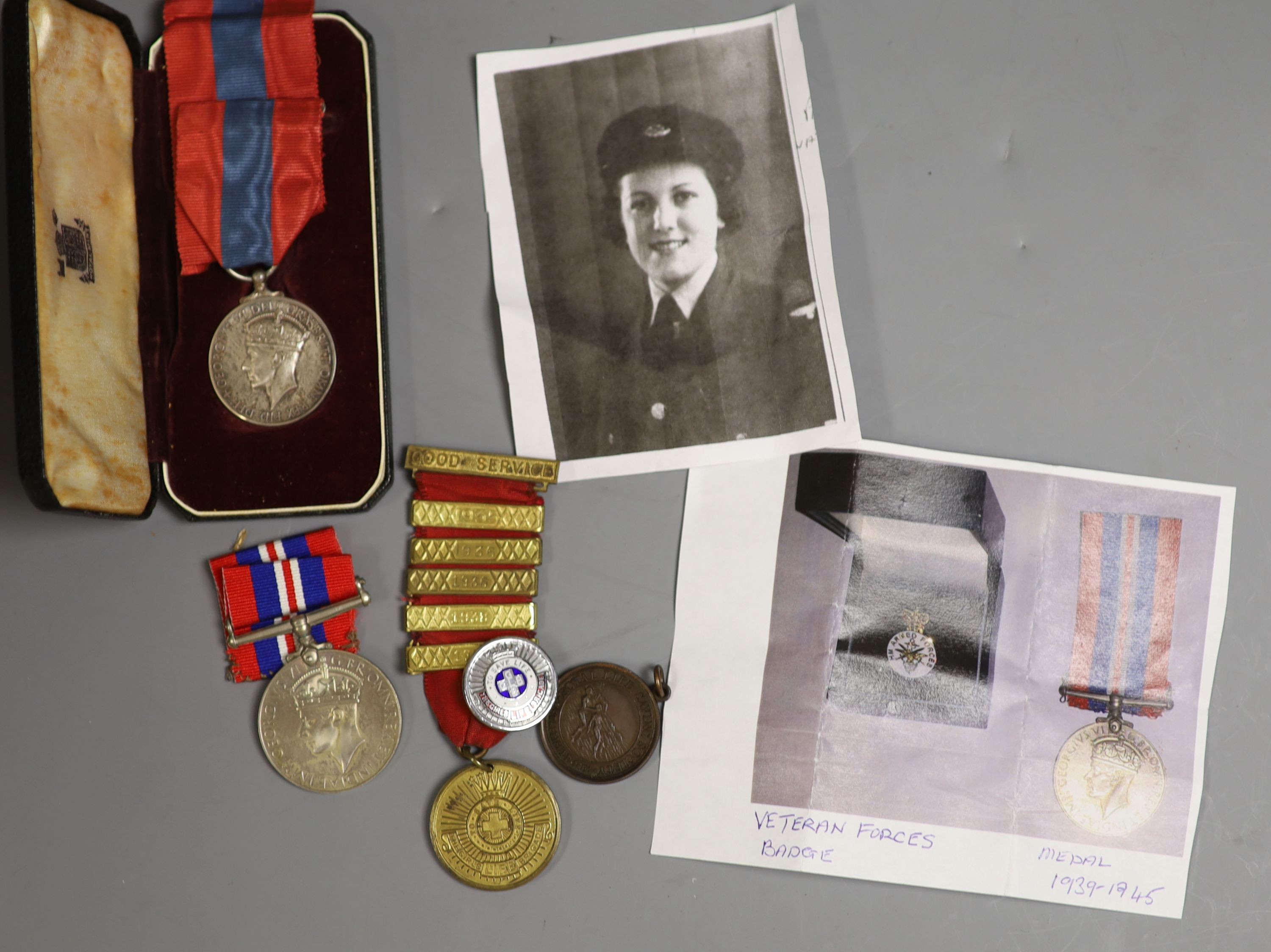 A military Union Flag and American Flag, sheepskin jerkin, 2nd war medal to S/SJT W L Blissett and ISM to Adelina Emily Prince